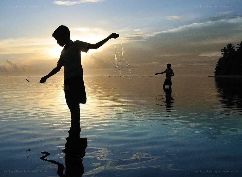 Children fishing at sunset