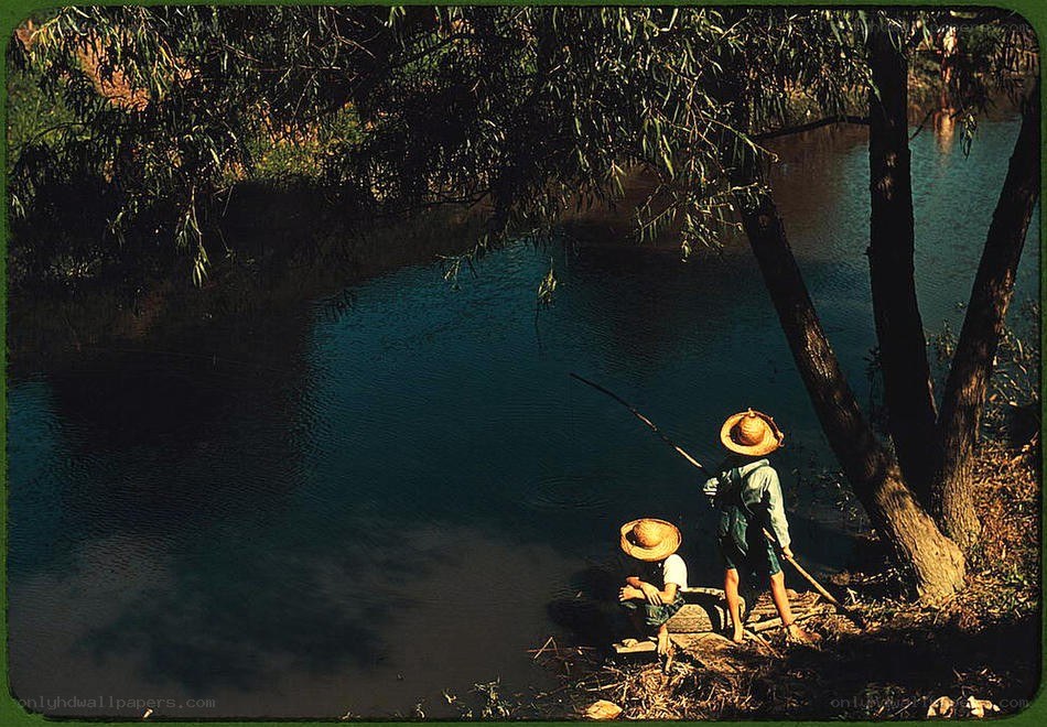 Children fishing by a river