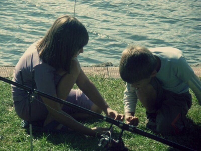 Children fishing by the water