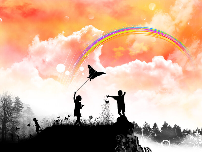 Children flying kites at sunset