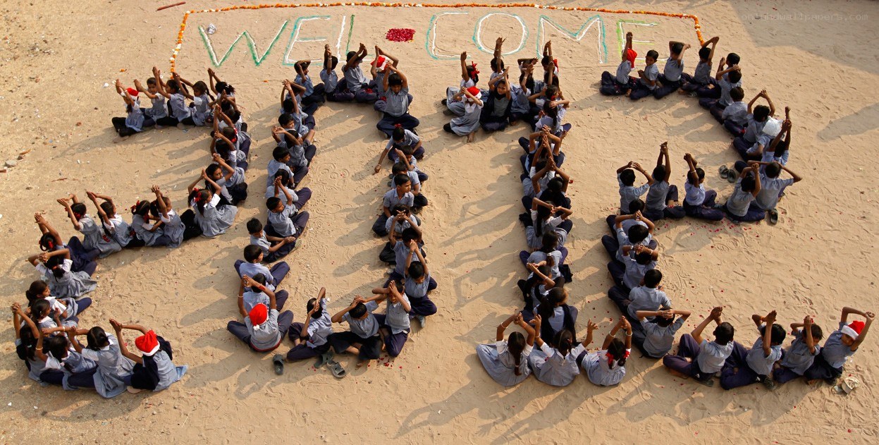 Children forming welcome message