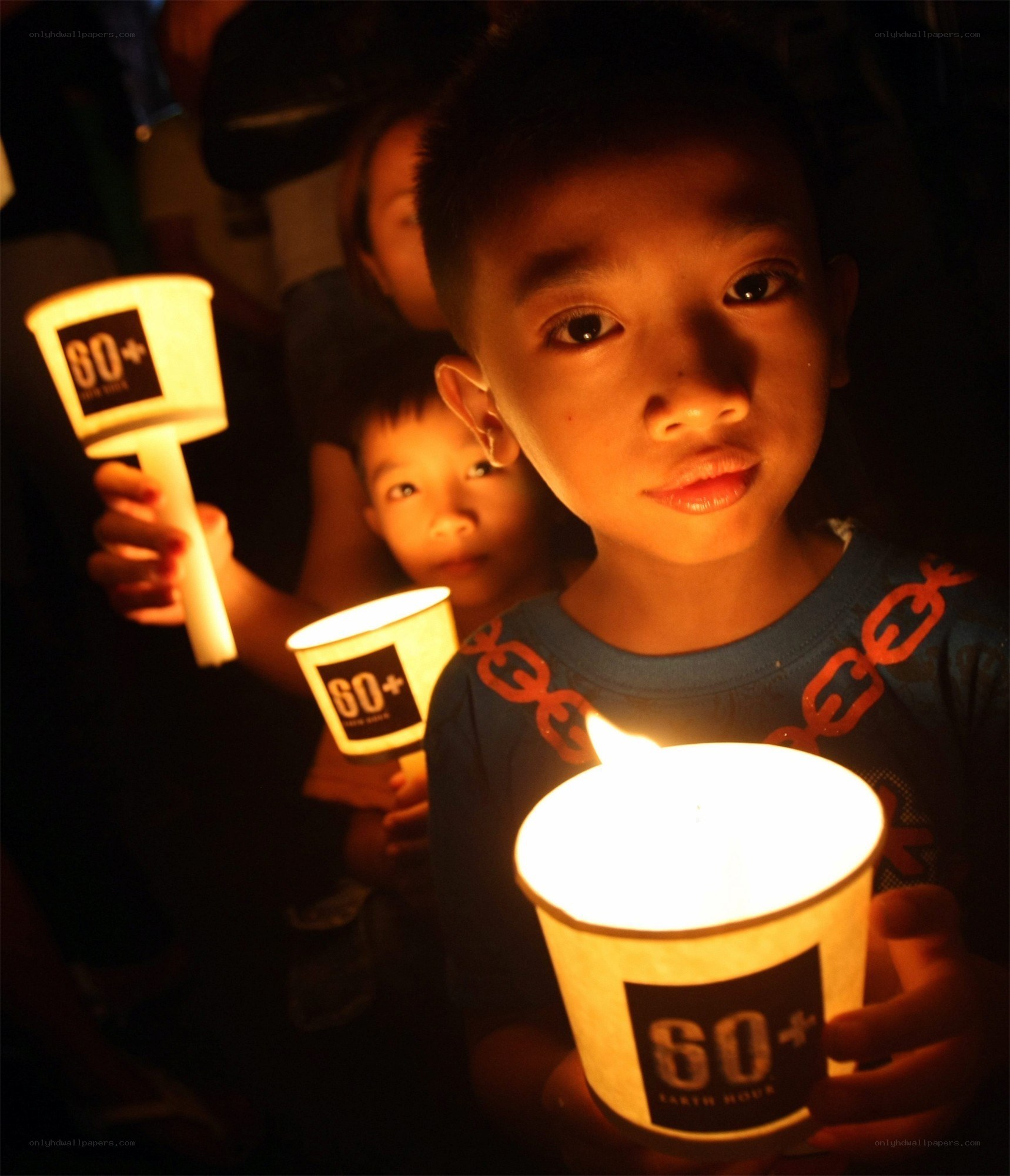 Children holding candles at event