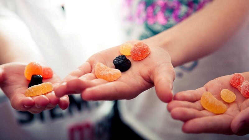 children holding colorful candies