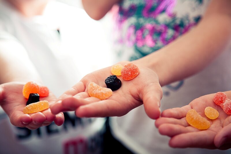 children holding colorful candies