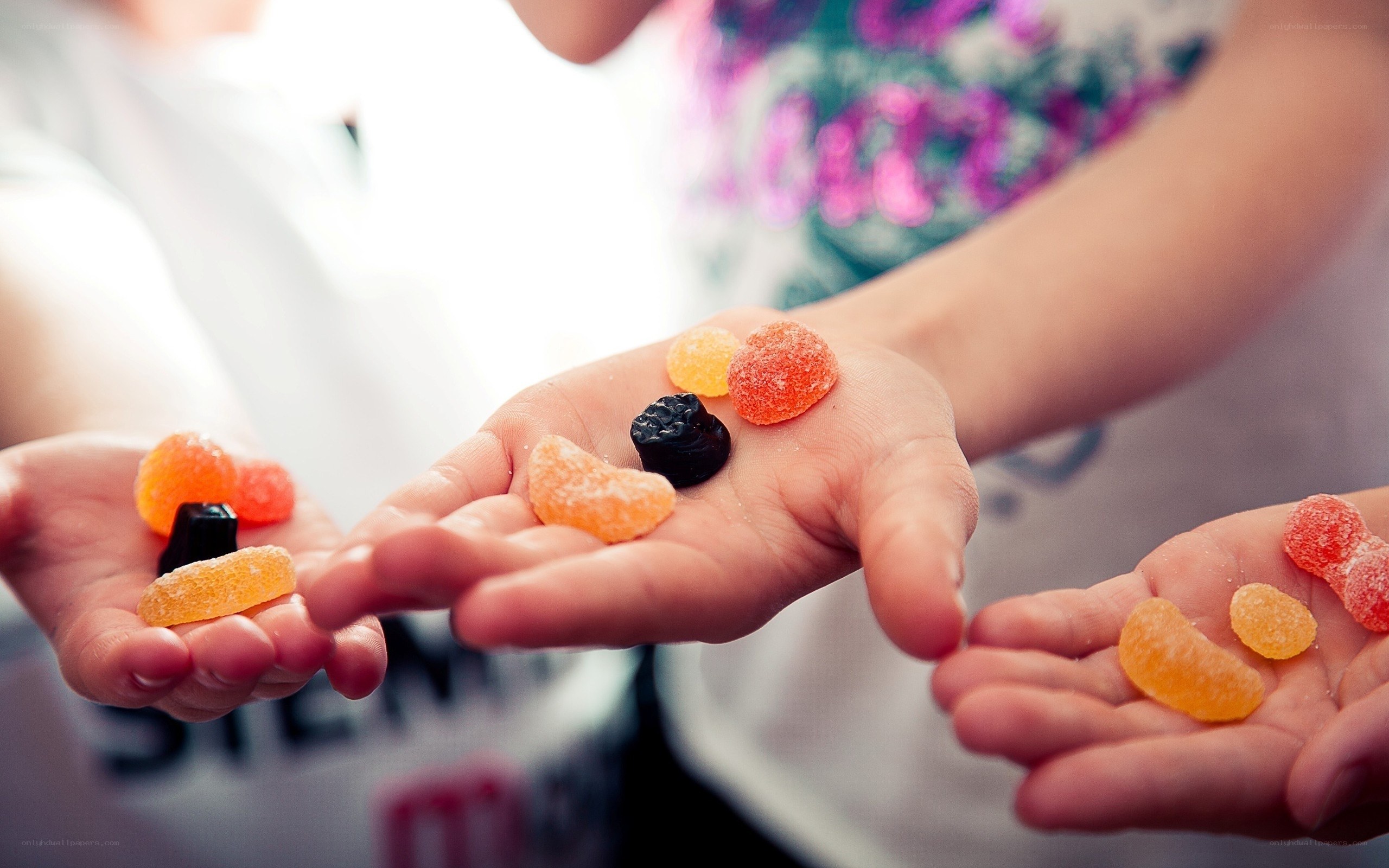 children holding colorful candies