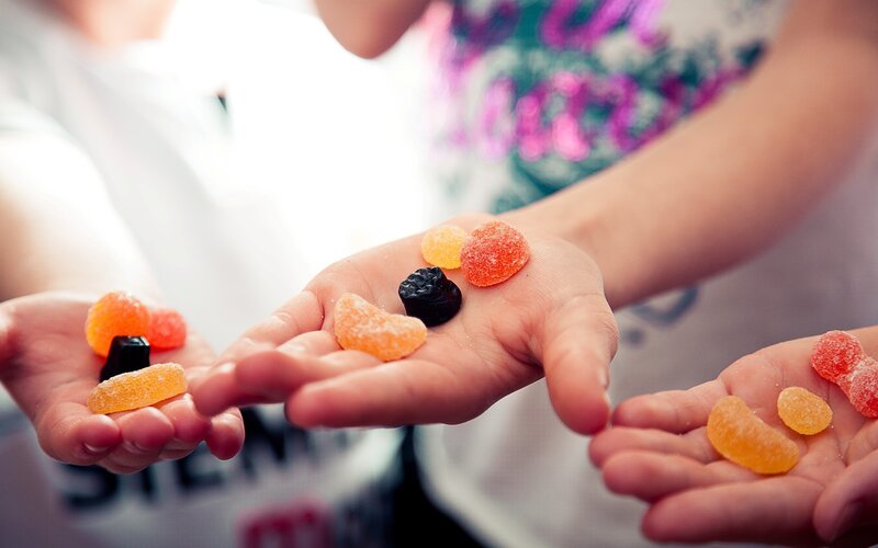 children holding gummy candies