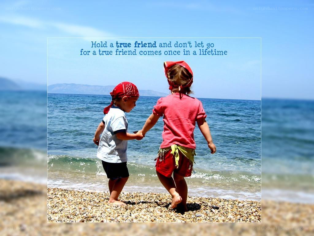 children holding hands at beach