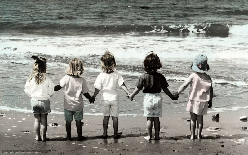 children holding hands at beach