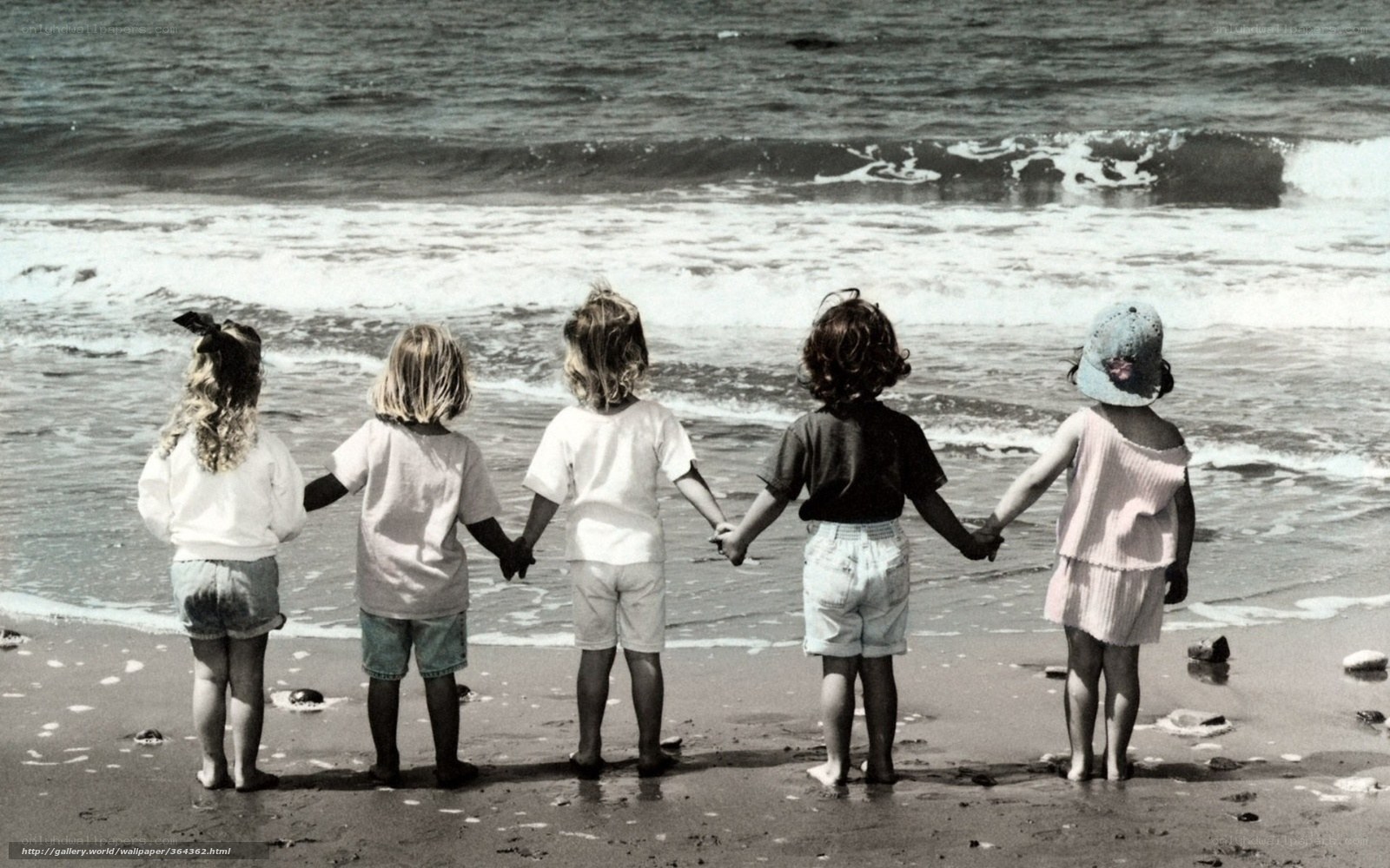 children holding hands at beach