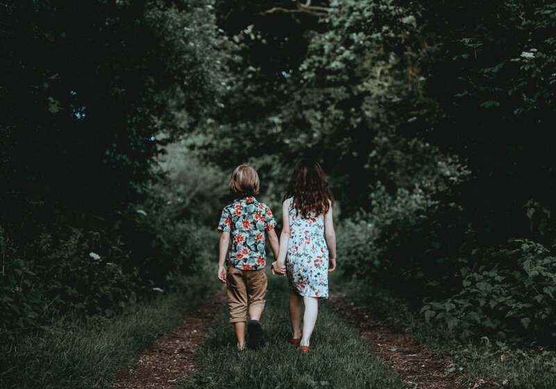 children holding hands in forest