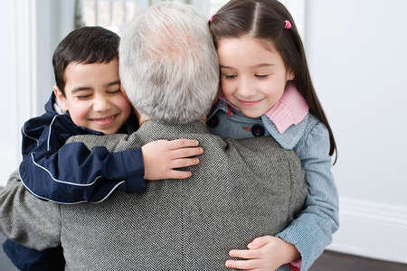 children hugging grandfather