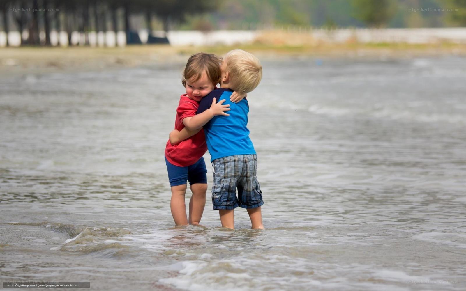 children hugging in shallow water