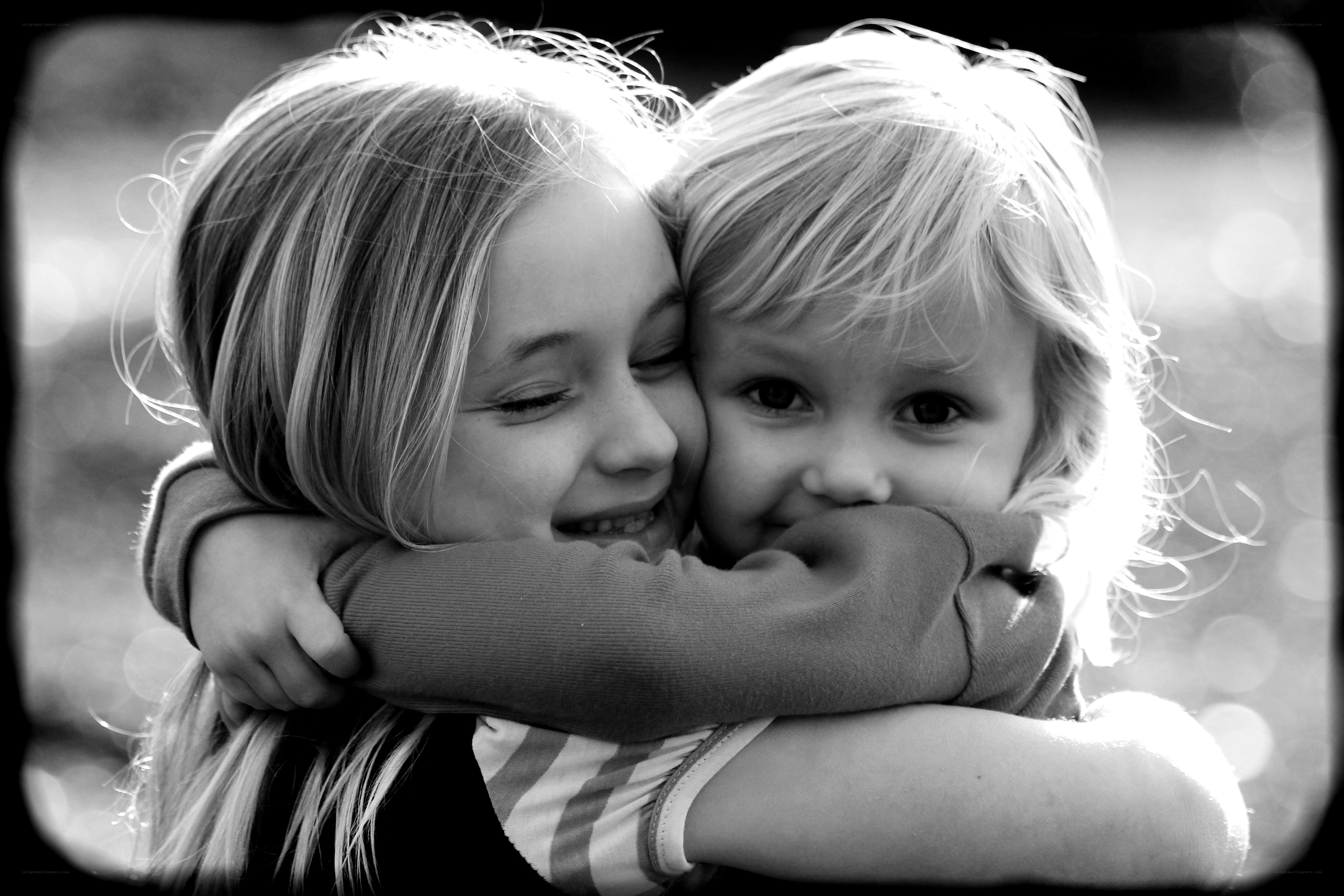 children hugging in sunlight