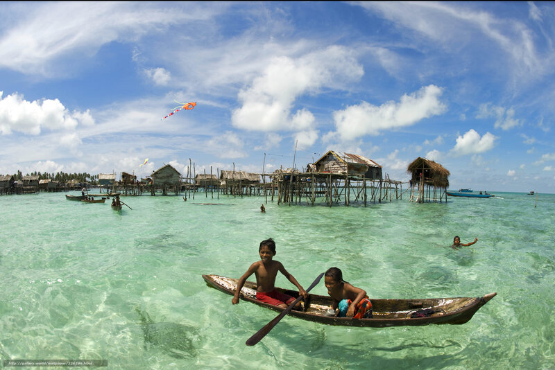 Children in a boat near stilt houses