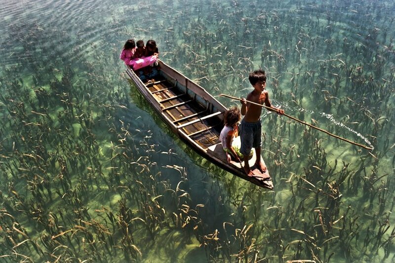 Children in a boat on clear water