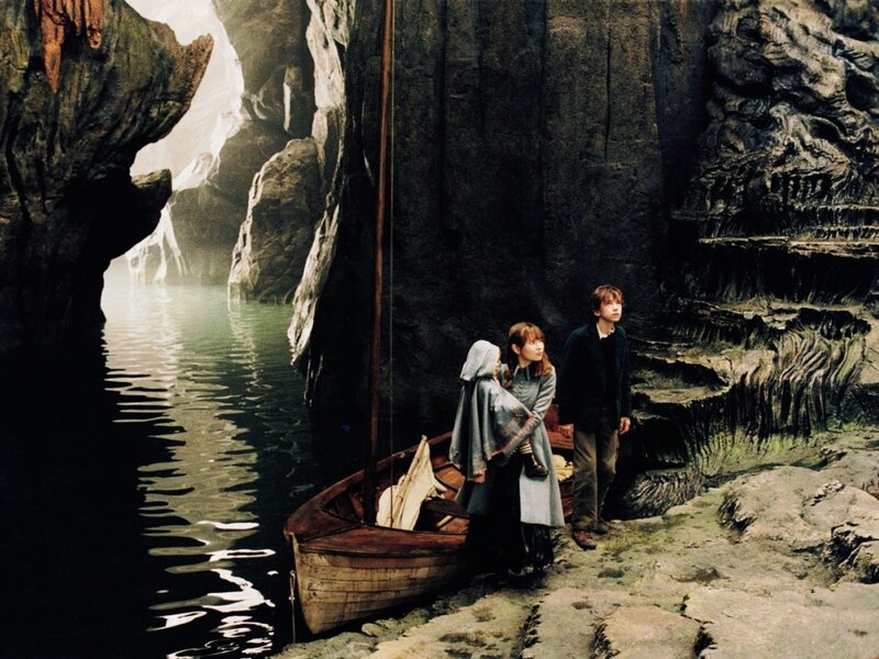 children in a cave with a boat