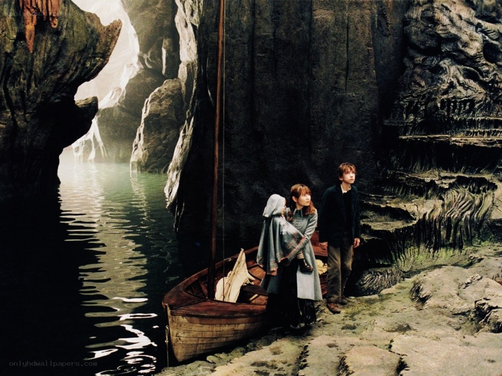 children in a cave with a boat