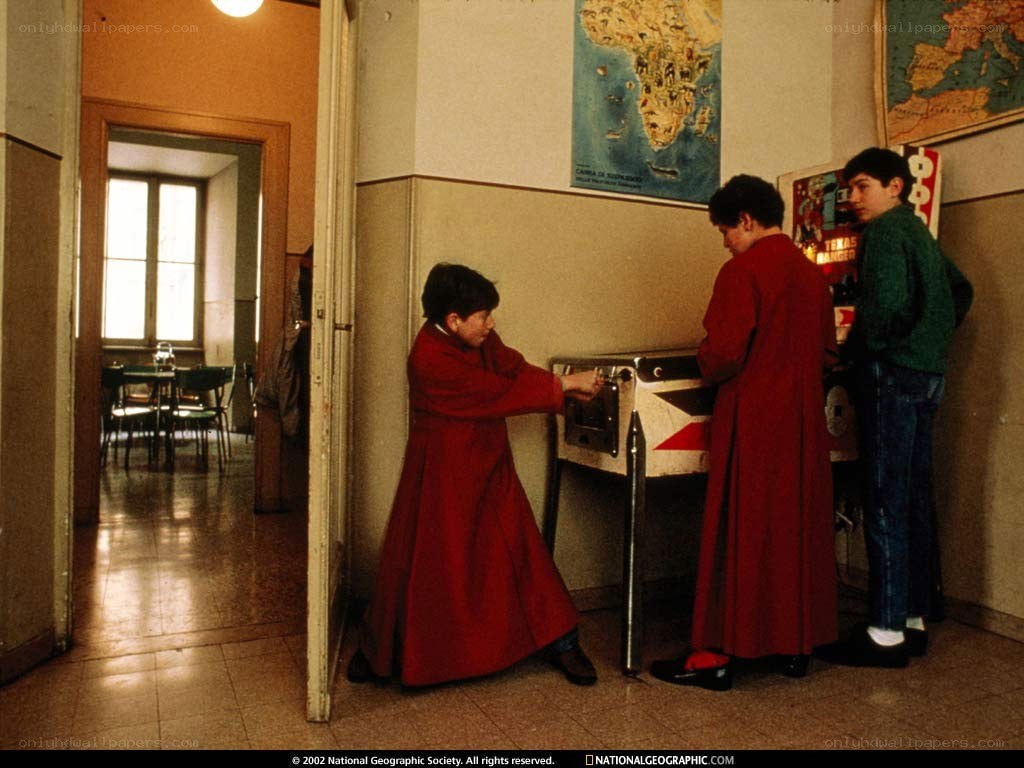 Children in red robes at a school