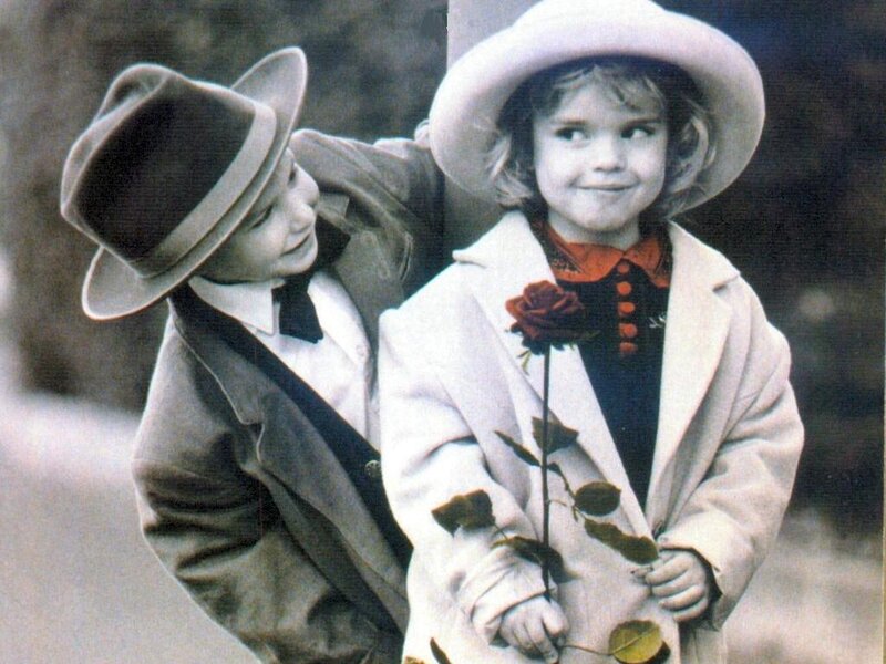 Children in vintage clothing with rose