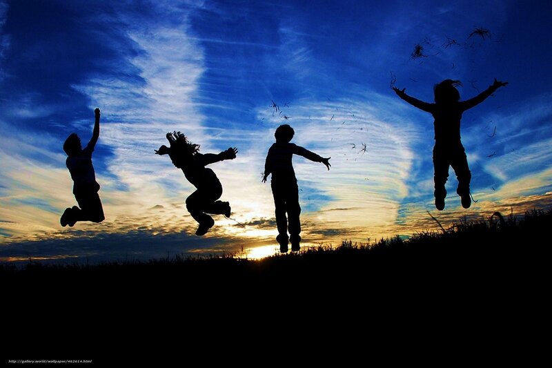 Children jumping at sunset