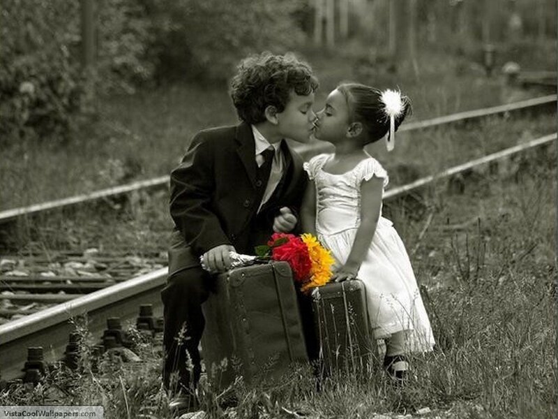children kissing by train tracks