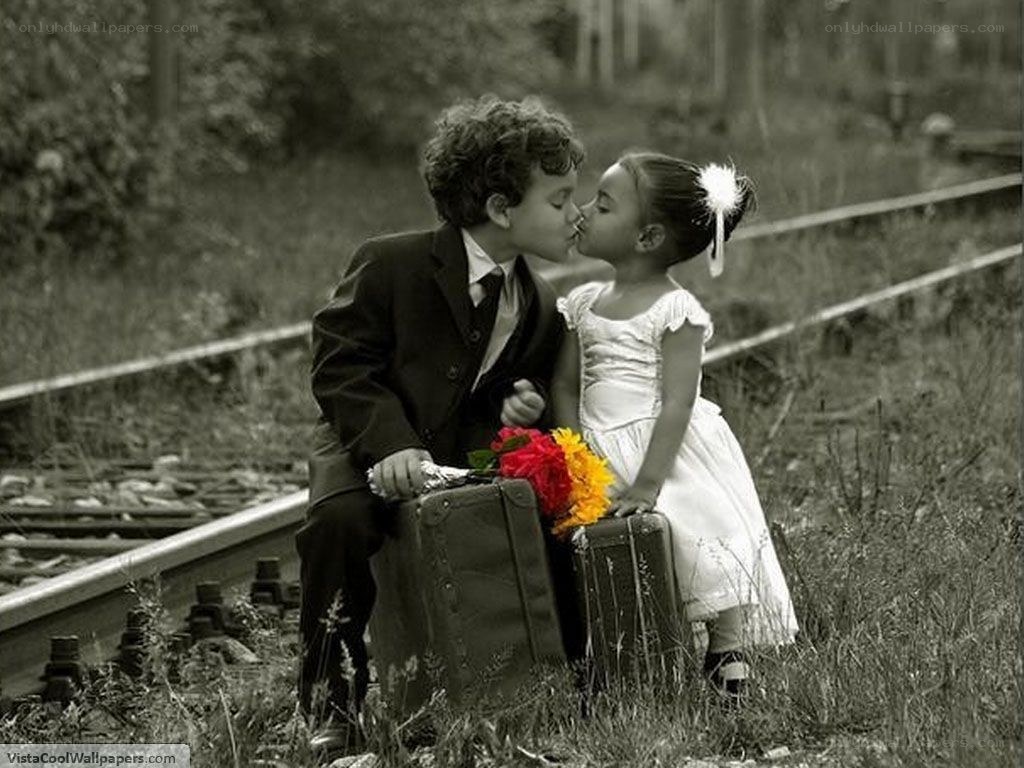 children kissing by train tracks