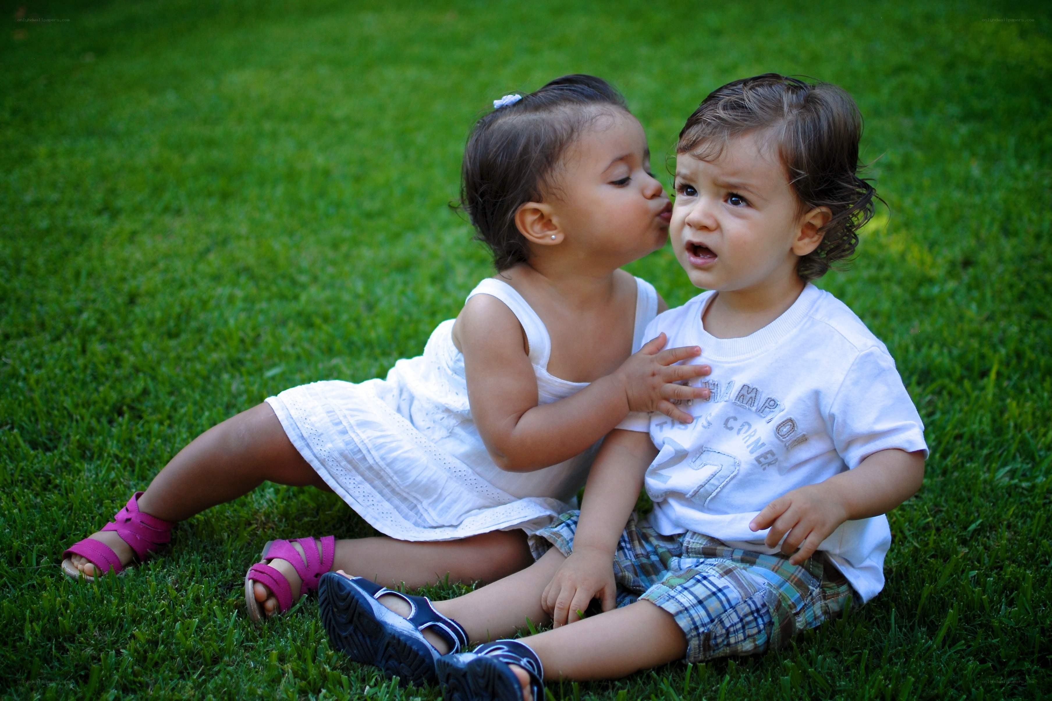 children kissing on grass