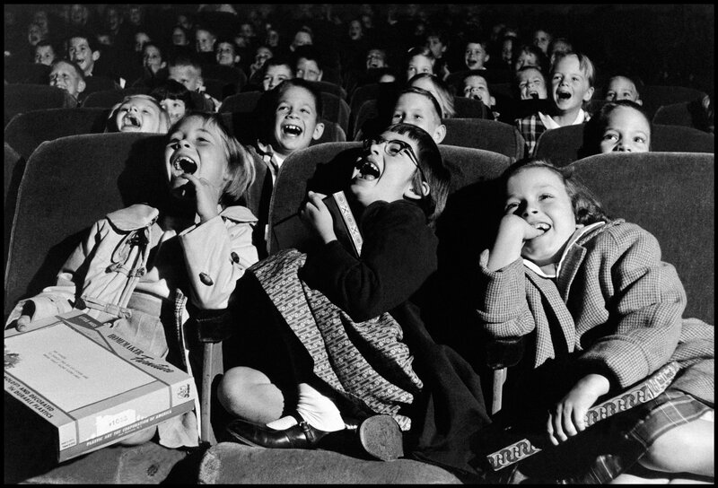 Children laughing in a theater