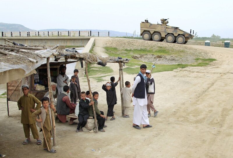 Children near military vehicle