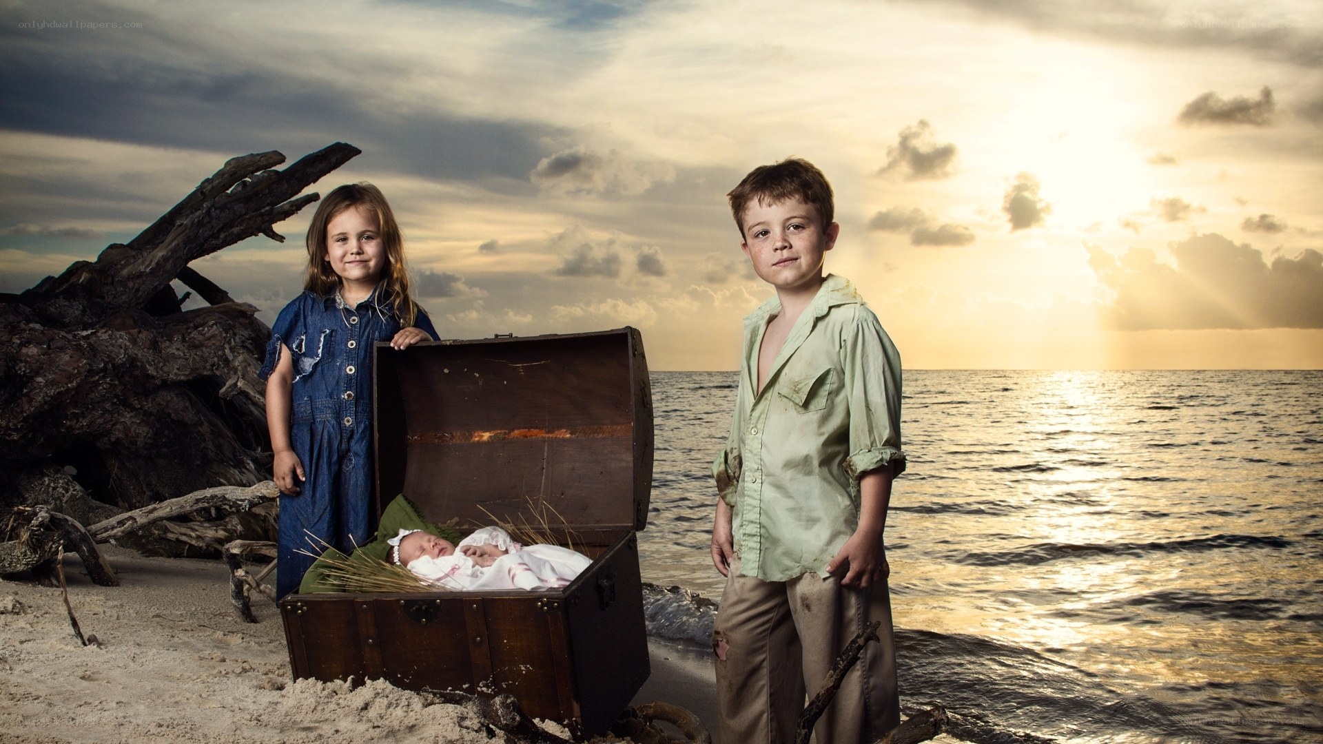 children on a beach with a chest