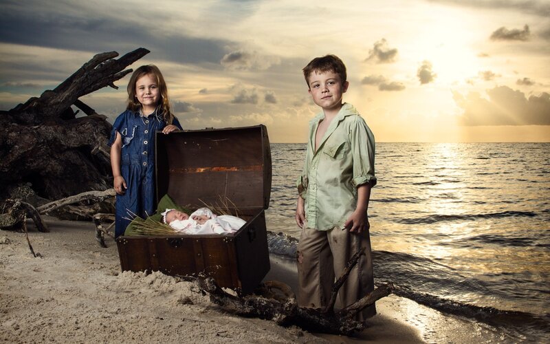 children on a beach with treasure chest
