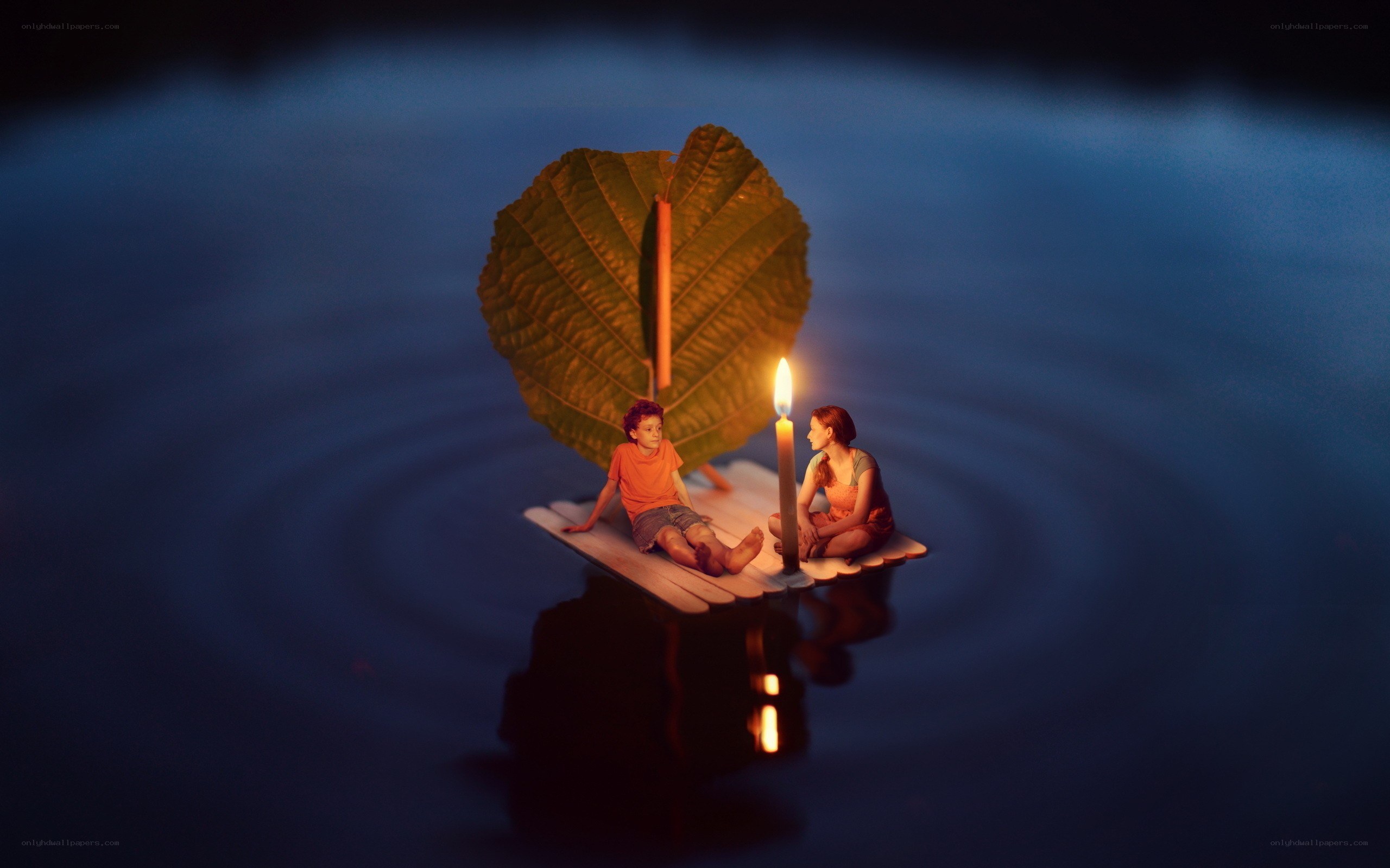 Children on a leaf raft at night
