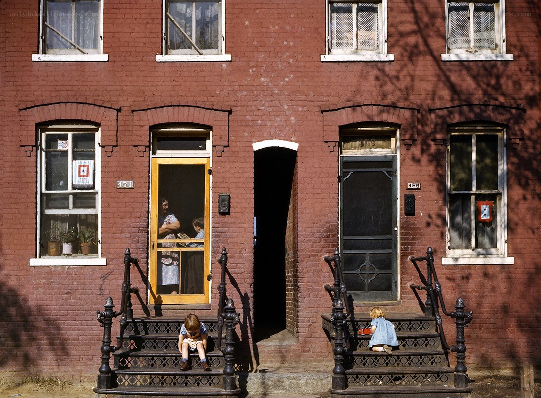 Children on brick house steps