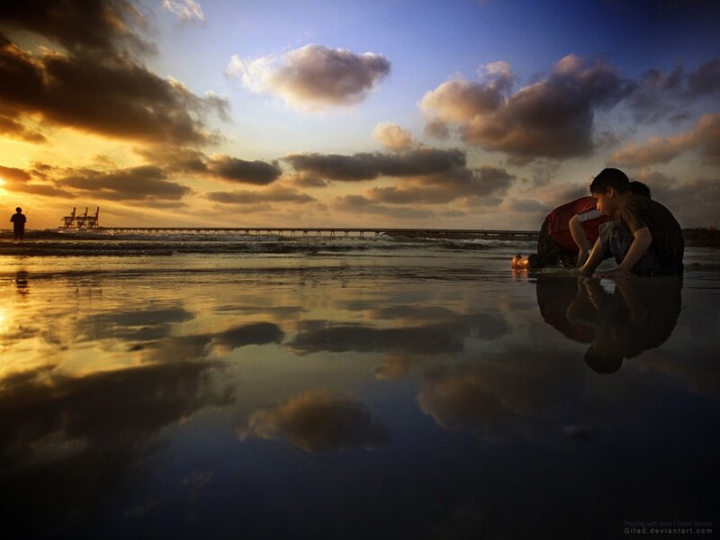 Children playing at sunset on the beach