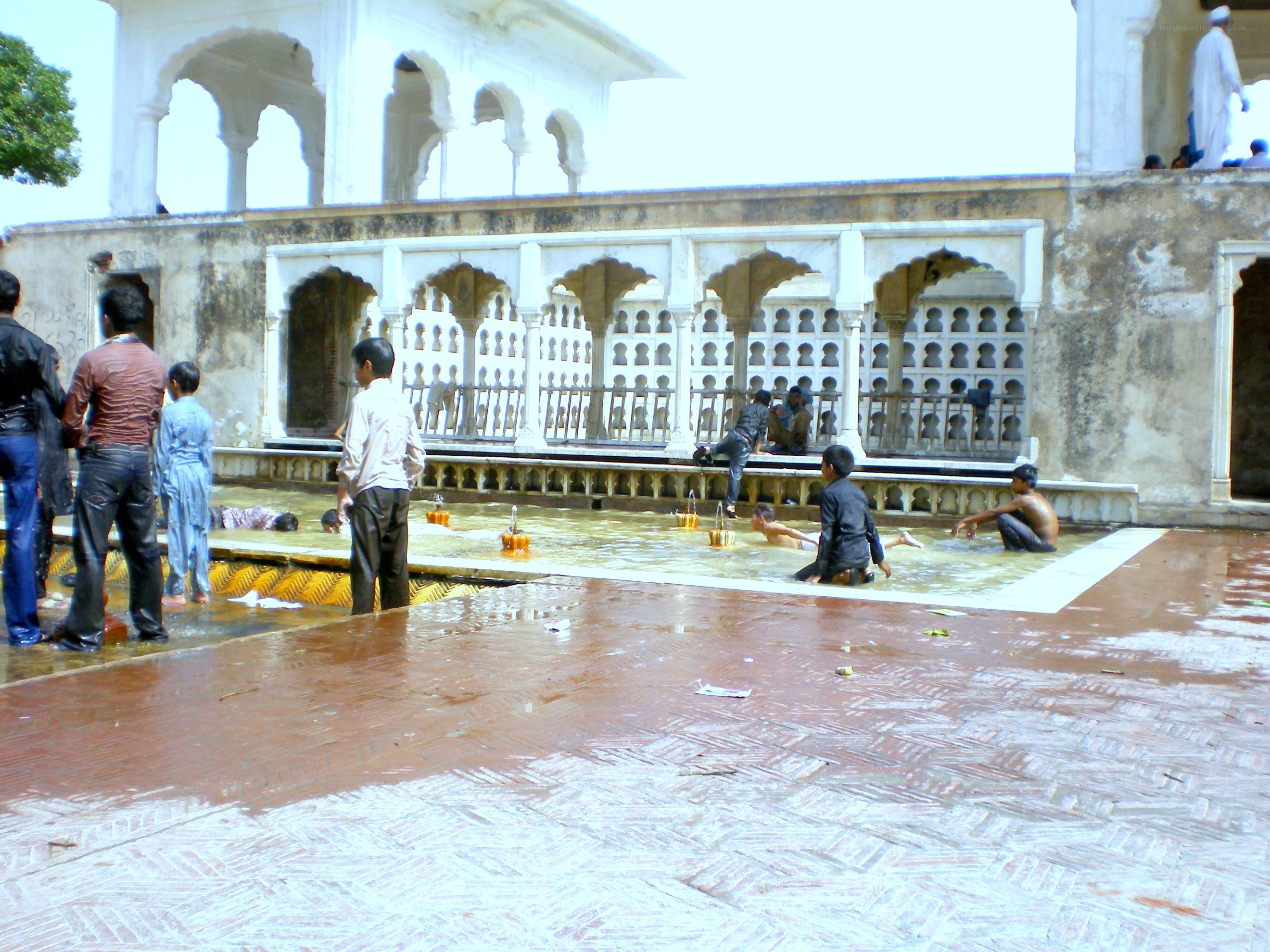 Children playing in a temple pool