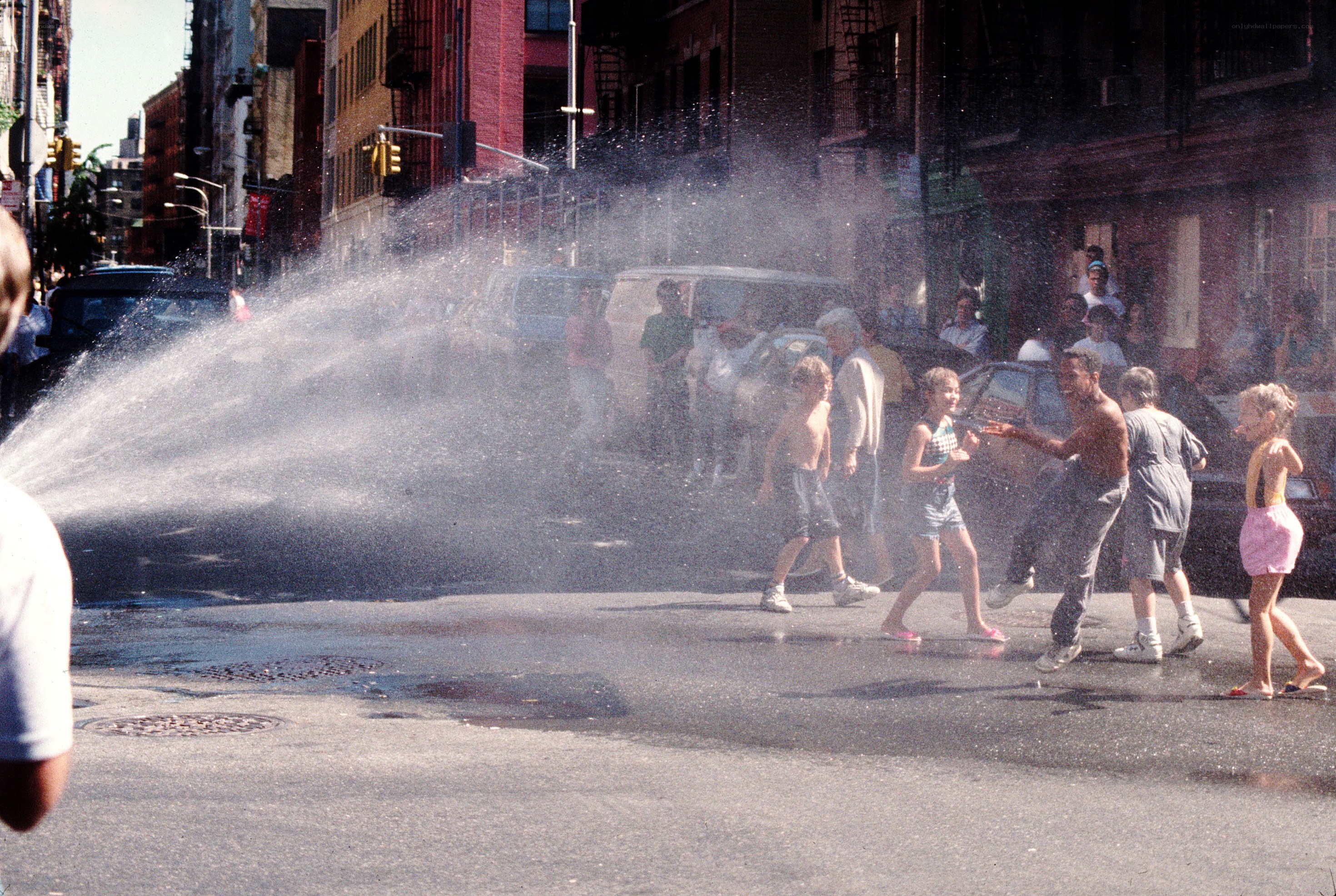Children playing in a water spray