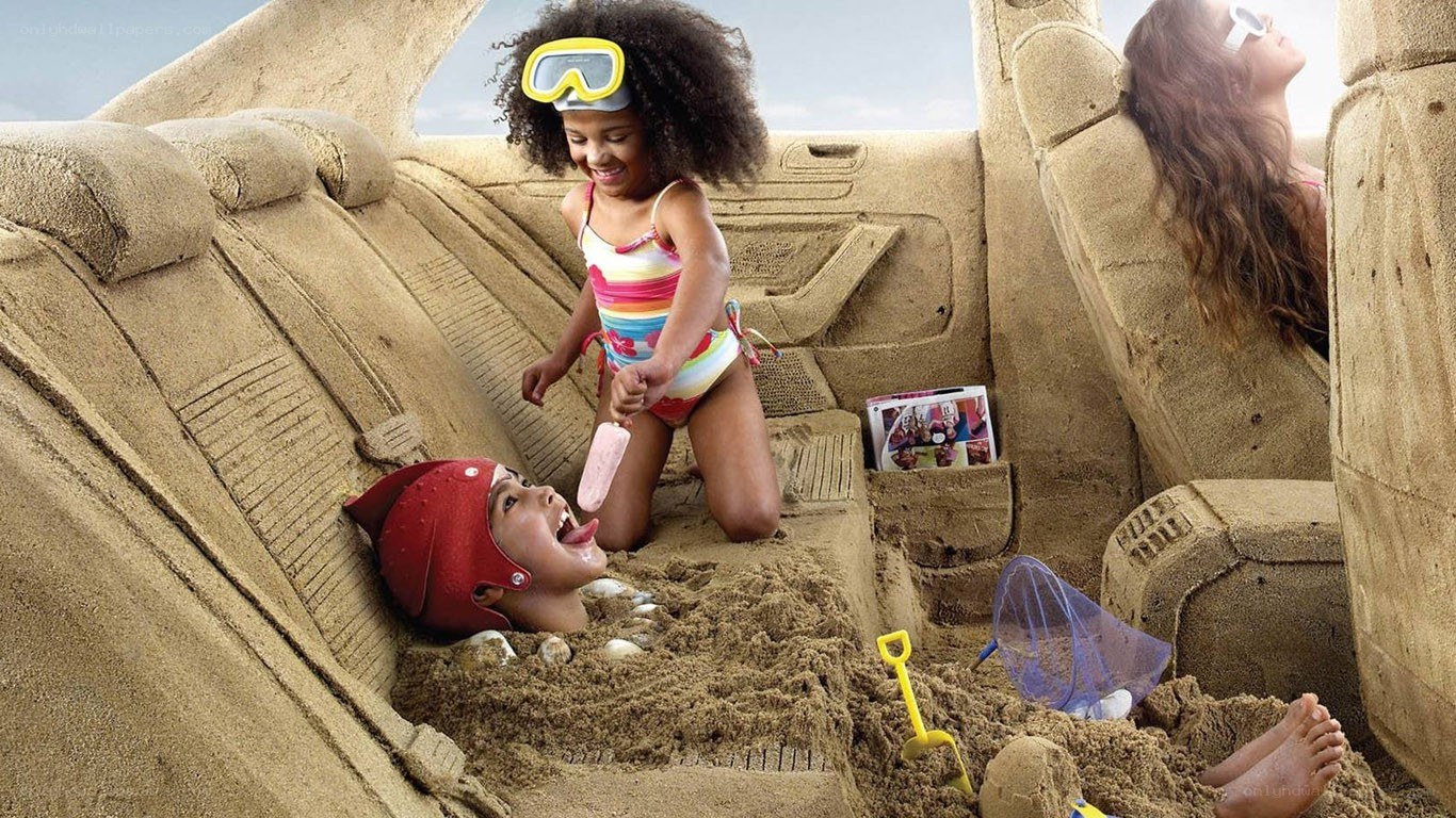 Children playing in sand-car