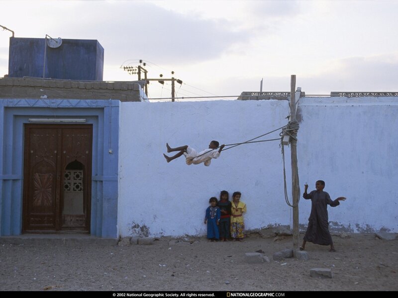 Children playing on a swing