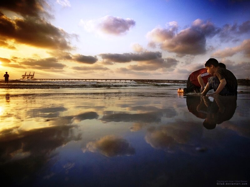 Children playing on beach at sunset
