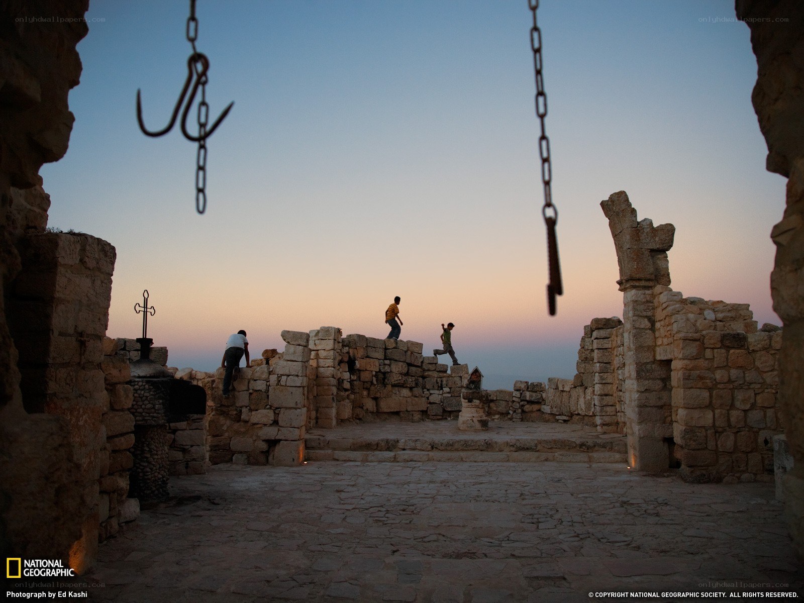 Children playing on ruins at dusk