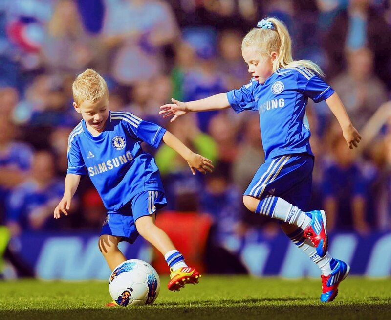 Children playing soccer in Chelsea jerseys
