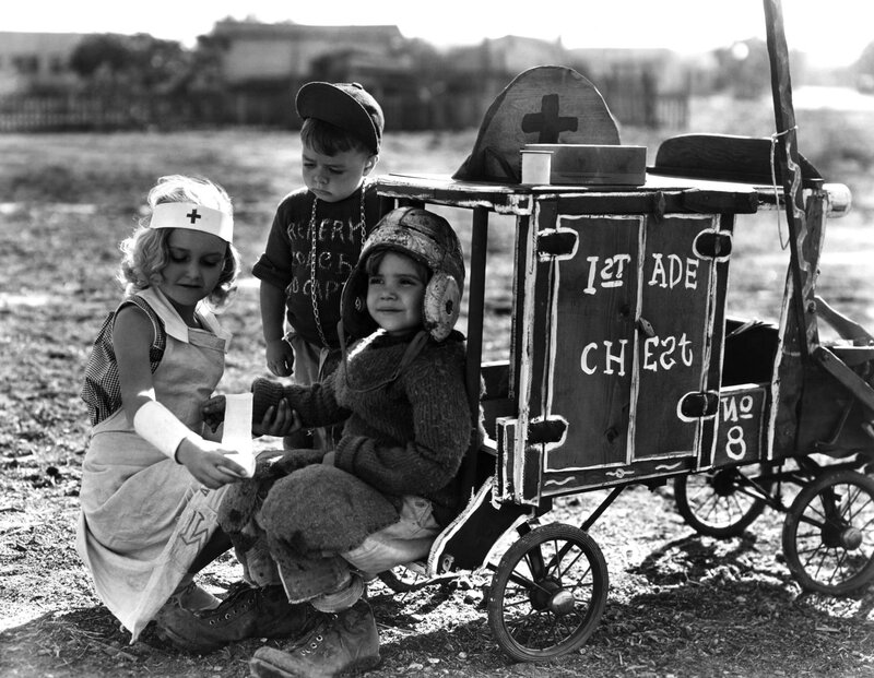 Children playing with a toy ambulance