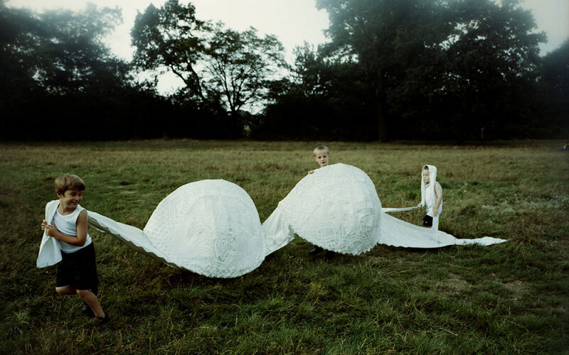 Children playing with a white sculpture