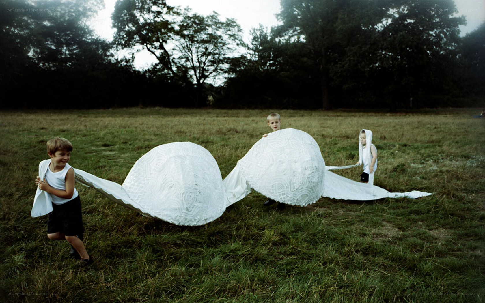 Children playing with a white sculpture