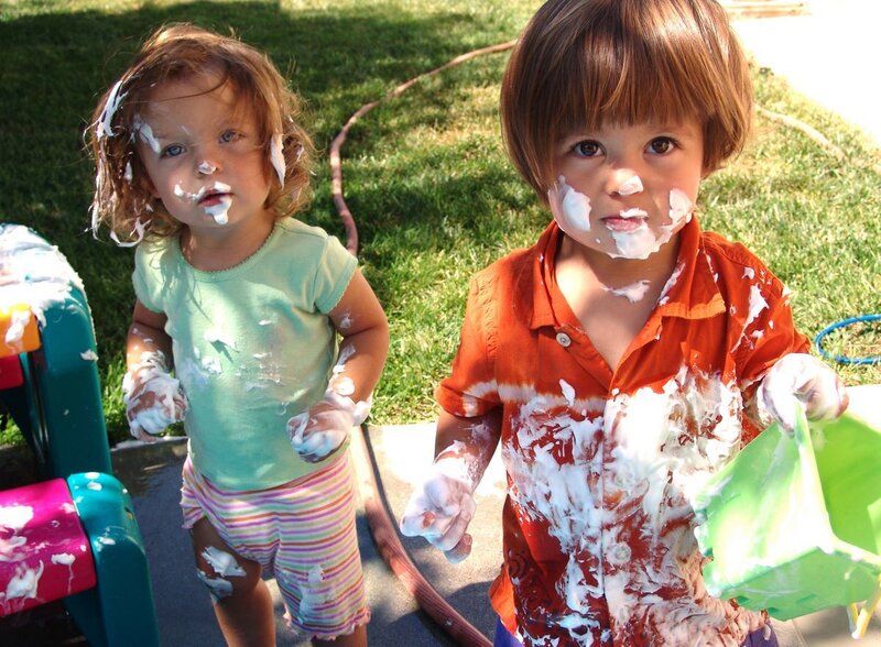 children playing with foam outdoors