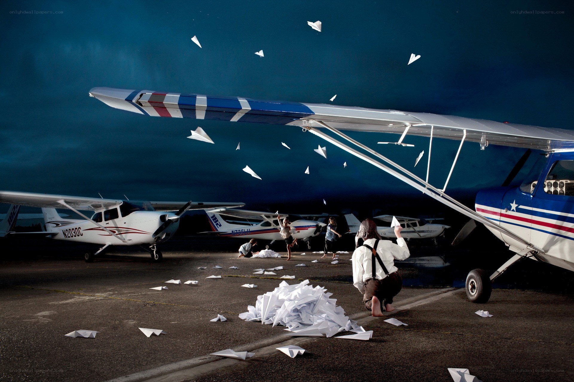 Children playing with paper airplanes