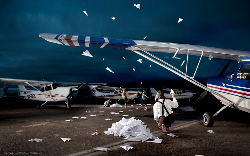 Children playing with paper airplanes