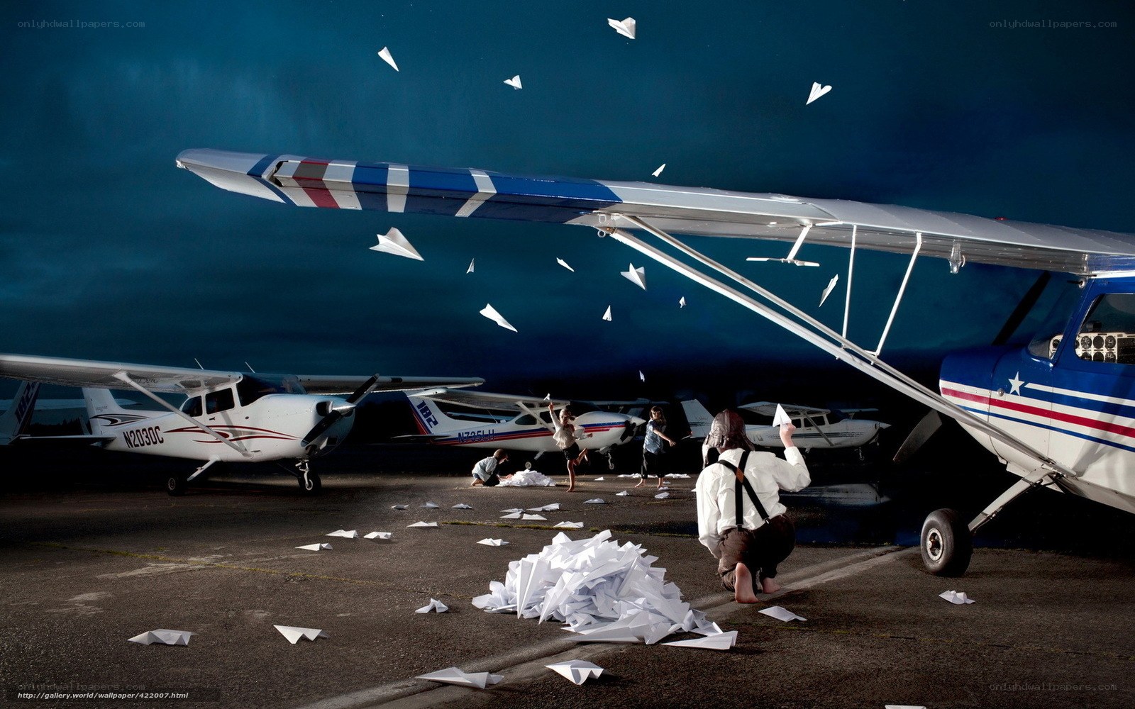 Children playing with paper airplanes