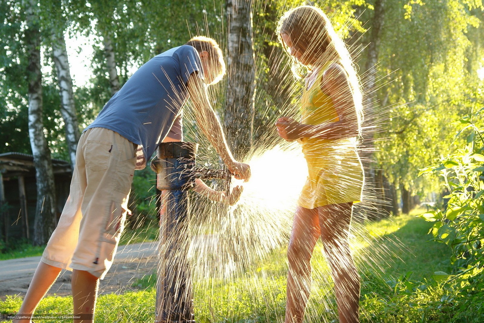 Children playing with water spray