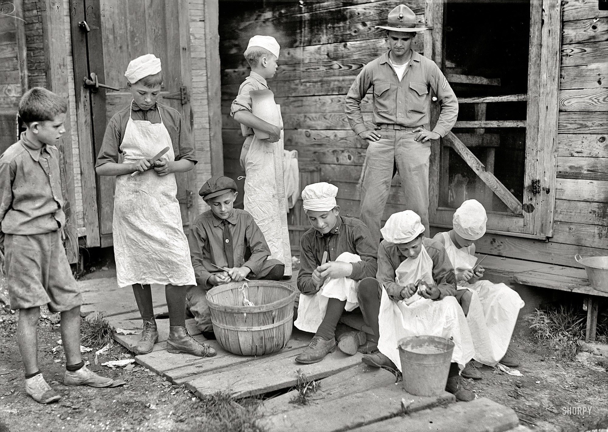 Children preparing food with soldier